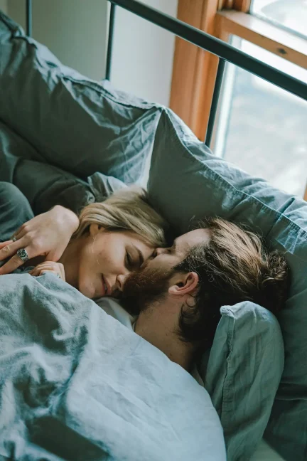 Couple relaxing together in bed in a calm home setting